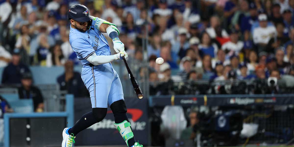 Toronto Blue Jays designated hitter Bo Bichette (11) hits an RBI single during the seventh inning against the Los Angeles Dodgers during game five of the 2025 MLB World Series at Dodger Stadium.