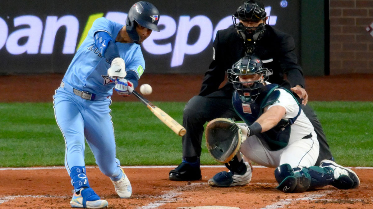 Toronto Blue Jays second baseman Andres Gimenez (0) hits a two-run home run in the third inning in front of Seattle Mariners catcher Cal Raleigh (29) during game four of the ALCS round for the 2025 MLB playoffs at T-Mobile Park.