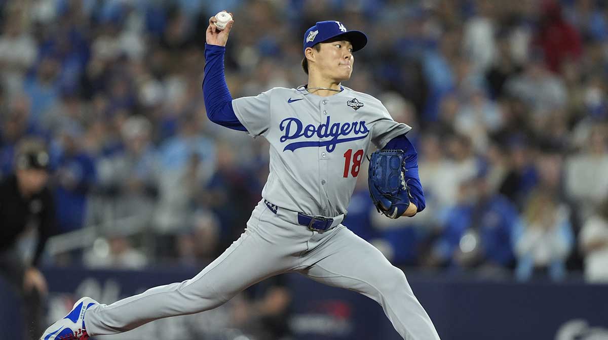 Los Angeles Dodgers pitcher Yoshinobu Yamamoto (18) pitches against the Toronto Blue Jays in the ninth inning during game two of the 2025 MLB World Series at Rogers Centre. Mandatory Credit: John E. Sokolowski-Imagn Images