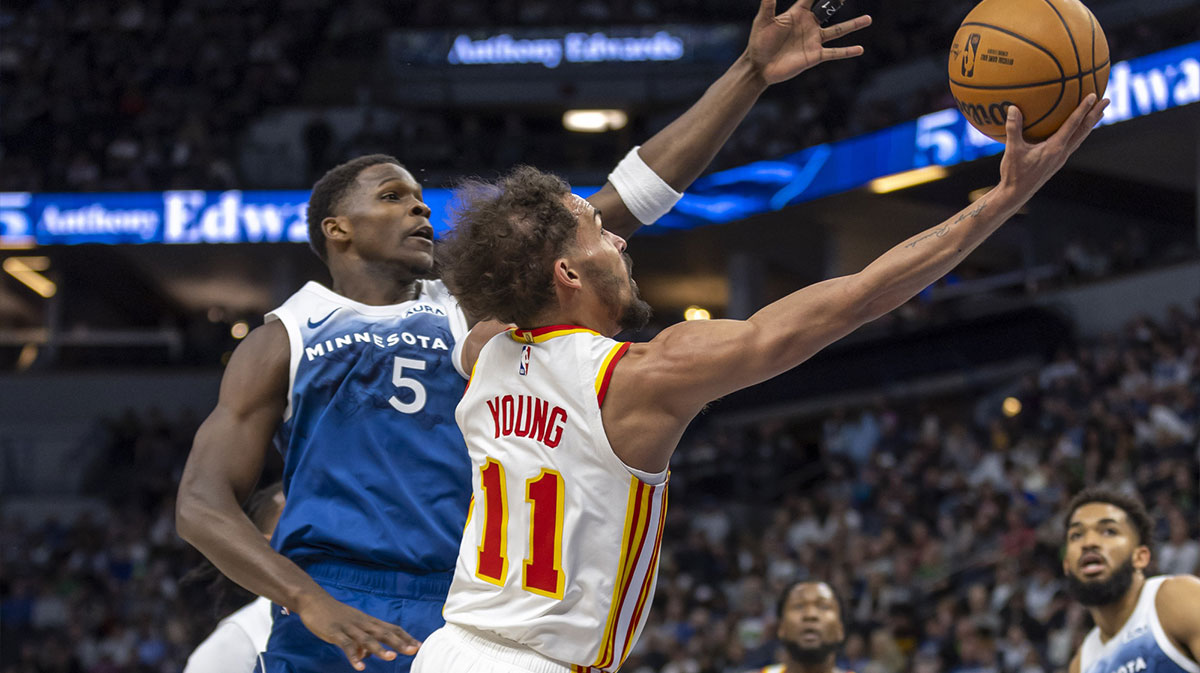 Atlanta Hawks guard Trae Young (11) drives to the basket past Minnesota Timberwolves guard Anthony Edwards (5) in the first half at Target Center.