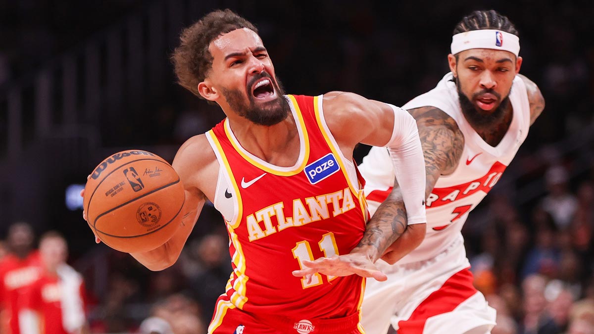 Atlanta Hawks guard Trae Young (11) is fouled by Toronto Raptors forward Brandon Ingram (3) in the second quarter at State Farm Arena.