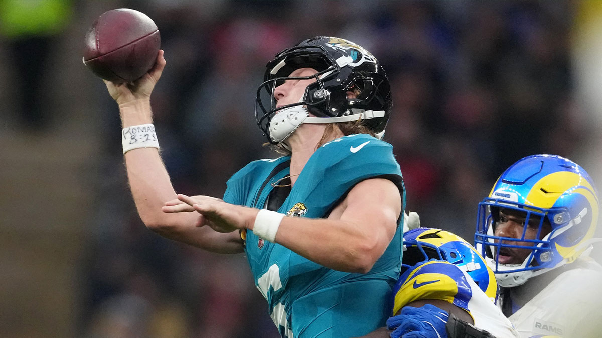 Los Angeles Rams linebacker Bryon Young (0) tackles Jacksonville Jaguars quarterback Trevor Lawrence (16) during the second half of an NFL International Series game at Wembley Stadium.