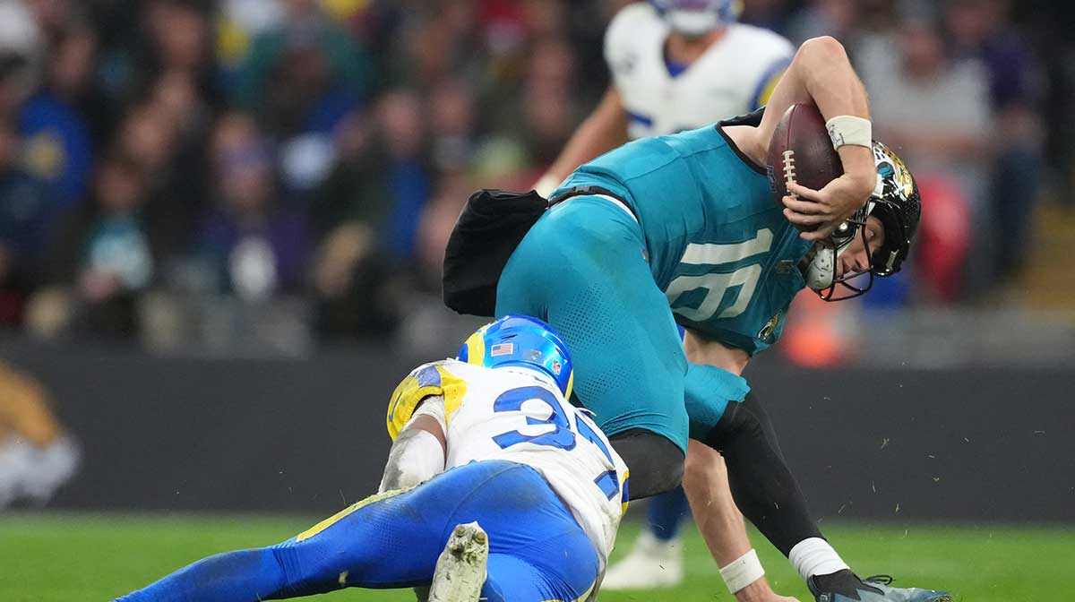 Los Angeles Rams safety Quentin Lake (37) sacks Jacksonville Jaguars quarterback Trevor Lawrence (16) during the second half of an NFL International Series game at Wembley Stadium.