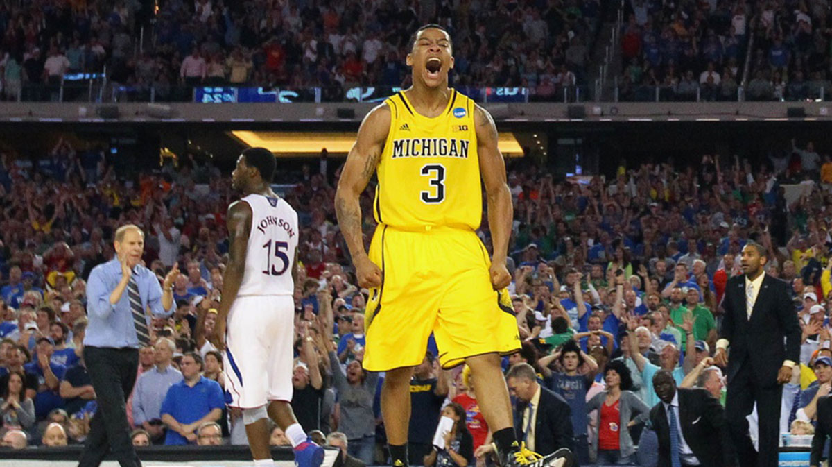 Mar 29, 2013; Arlington, TX, USA; Michigan Wolverines guard Trey Burke (3) reacts after hitting a three-point shot to tie the game with six seconds against the Kansas Jayhawks in the second half during the semifinals of the South regional of the 2013 NCAA Tournament at Cowboys Stadium. Mandatory Credit: Kevin Jairaj-Imagn Images