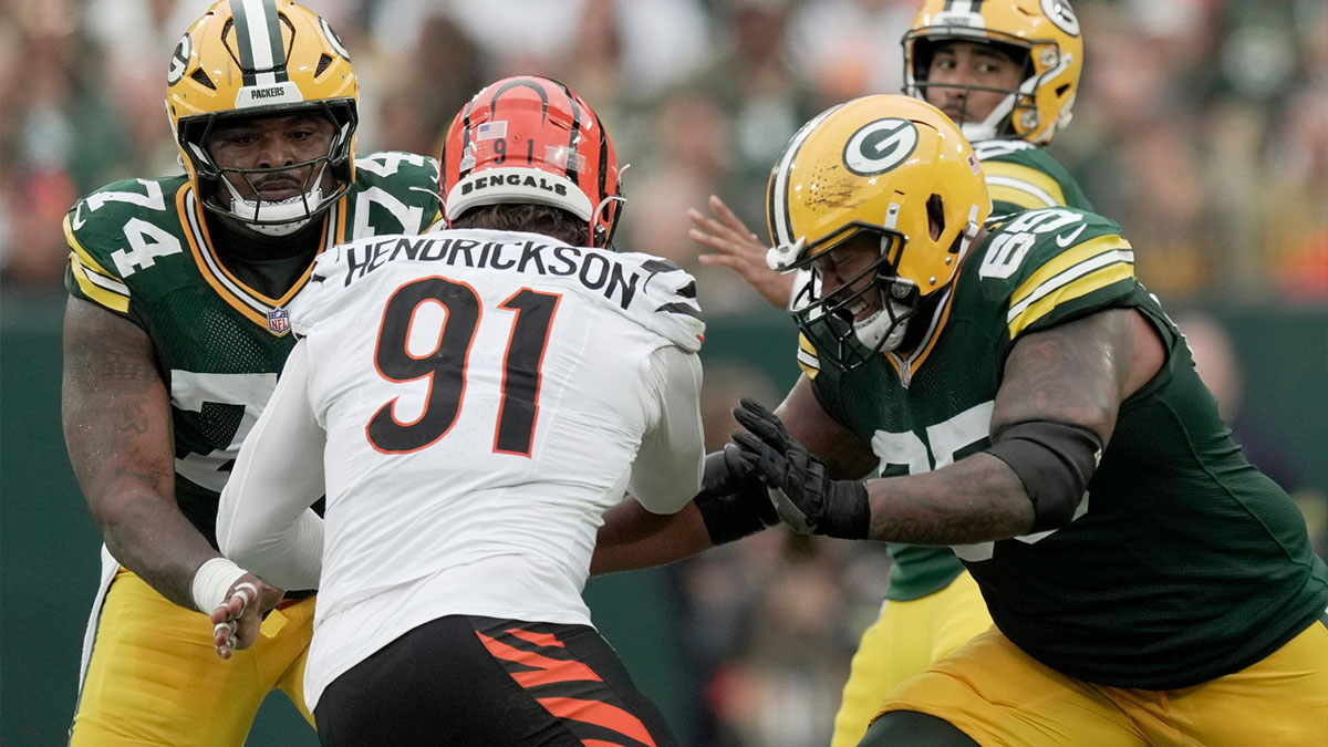 Cincinnati Bengals defensive end Trey Hendrickson (91) is double-teamed by Green Bay Packers center Elgton Jenkins (74) and guard Aaron Banks (65) during the second quarter of their game Sunday, October 12, 2025 at Lambeau Field in Green Bay, Wisconsin.
