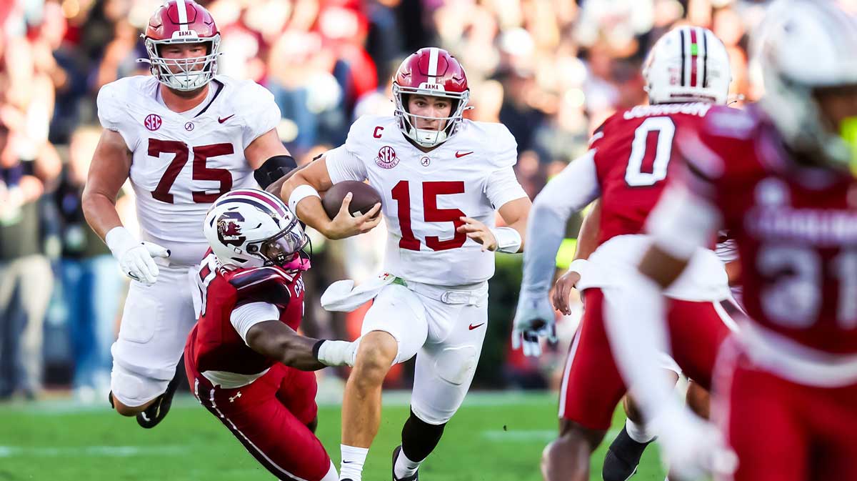 Alabama Crimson Tide quarterback Ty Simpson (15) scrambles for a first down on fourth down against the South Carolina Gamecocks in the second quarter at Williams-Brice Stadium.