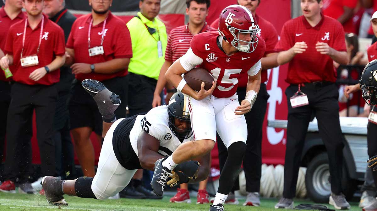 Alabama Crimson Tide quarterback Ty Simpson (15) is tackled by Vanderbilt Commodores defensive lineman Aaron Bryant (55) during the second half at Saban Field at Bryant-Denny Stadium.
