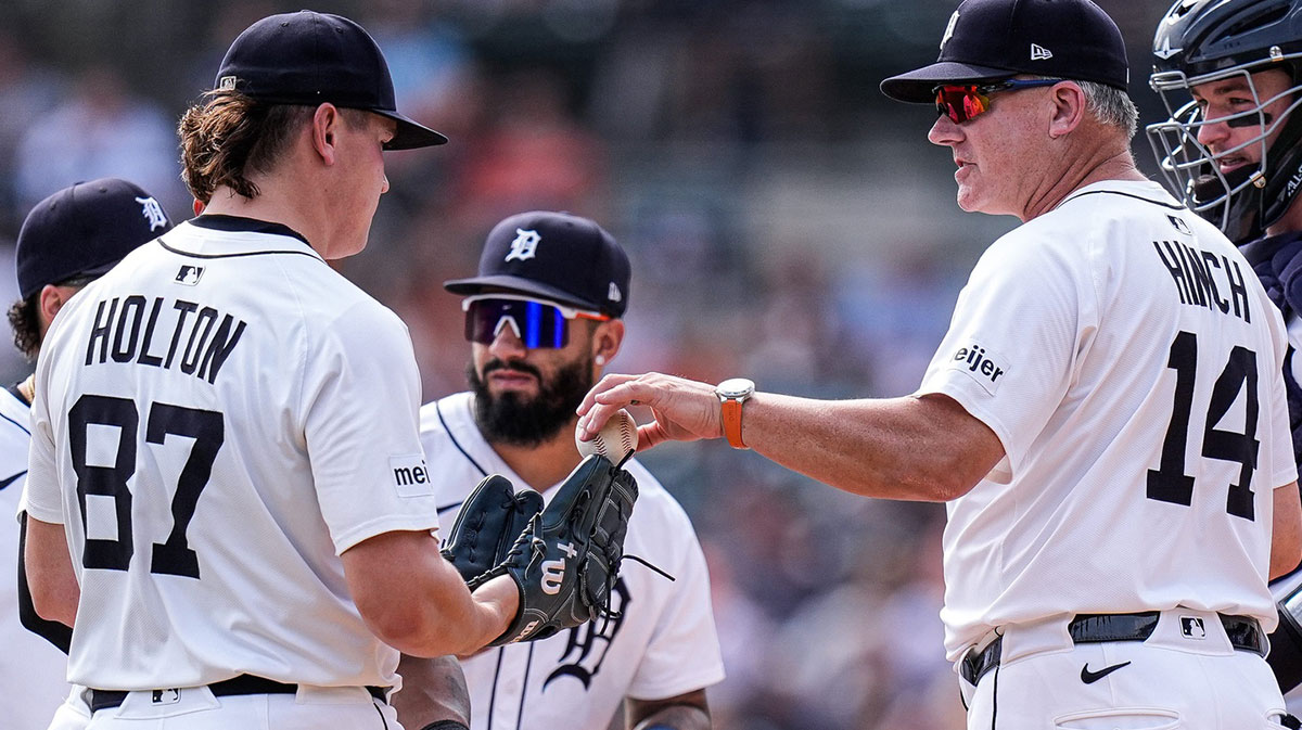 Detroit Tigers manager A.J. Hinch (14) hands the game ball to pitcher Tyler Holton (87) for a pitching change during the fifth inning against Atlanta Braves at Comerica Park.
