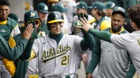 Athletics first baseman Tyler Soderstrom (21) celebrates with teammates after hitting a solo home run against the Chicago White Sox during the seventh inning at Rate Field.