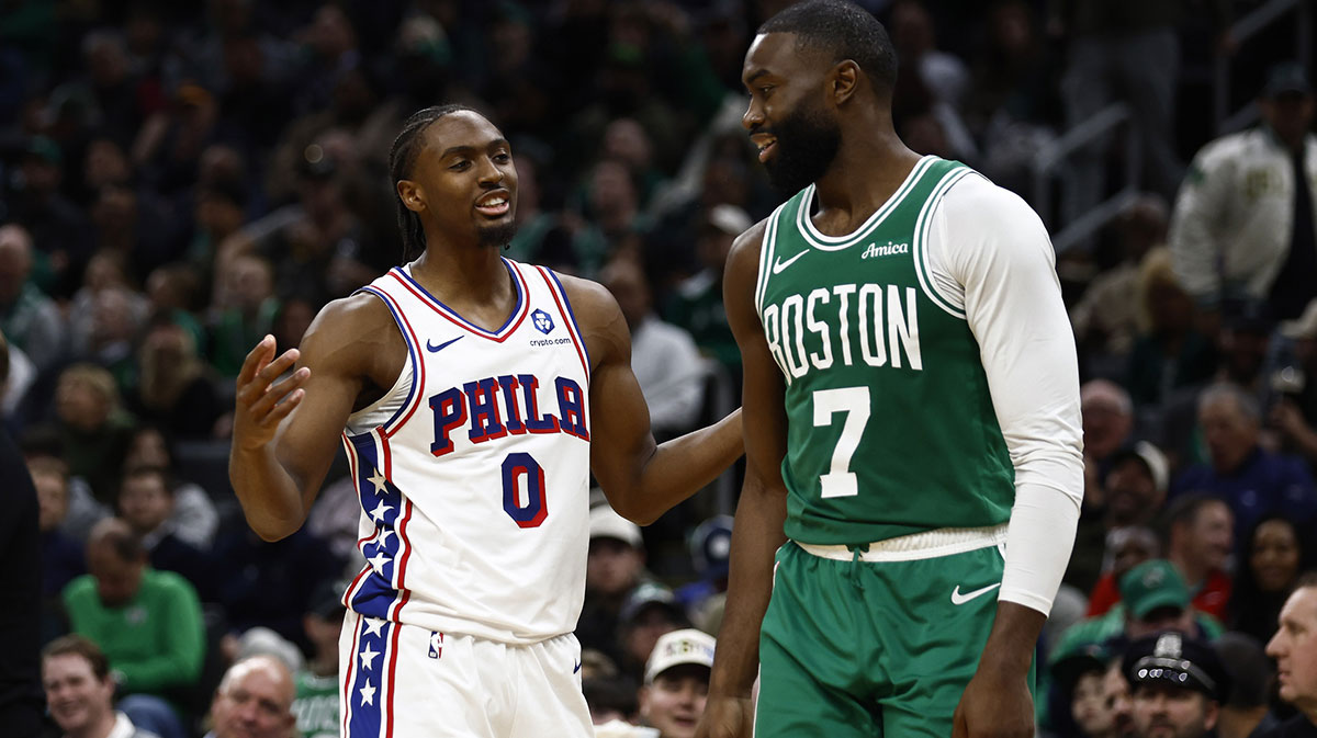 Philadelphia 76ers guard Tyrese Maxey (0) talks with Boston Celtics guard Jaylen Brown (7) during the second half at TD Garden.