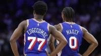 Philadelphia 76ers guard VJ Edgecombe (77) and guard Tyrese Maxey (0) look on during the third quarter against the Charlotte Hornets at Xfinity Mobile Arena.