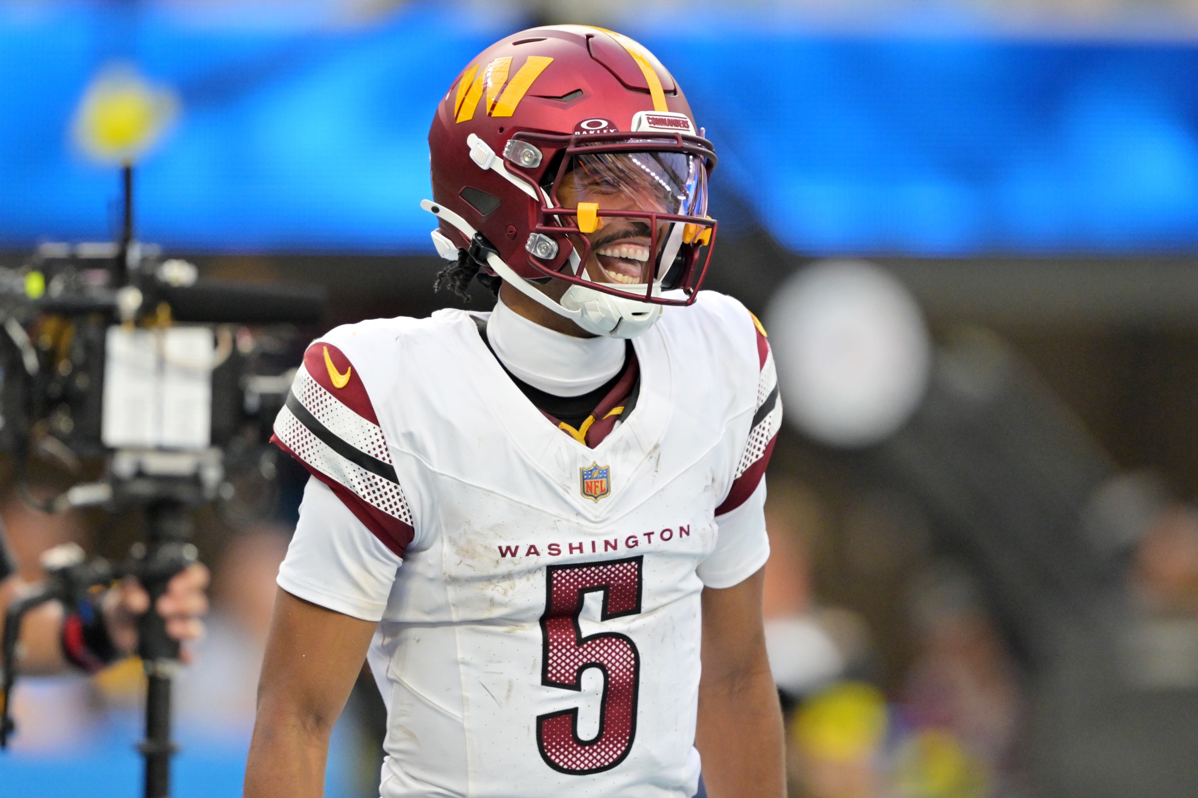 Washington Commanders quarterback Jayden Daniels (5) celebrates after a touchdown against the Los Angeles Chargers in the second half at SoFi Stadium.
