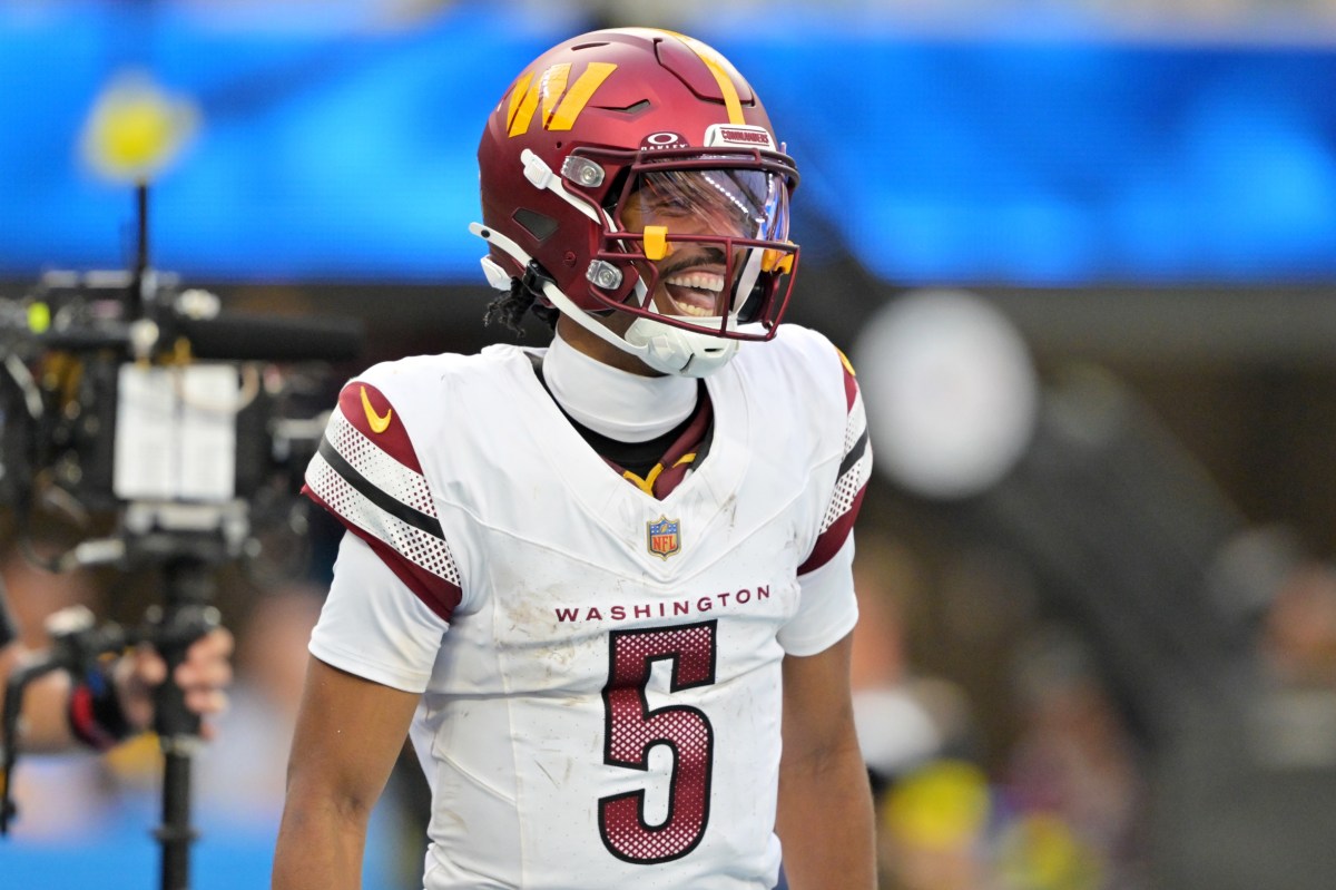 Washington Commanders quarterback Jayden Daniels (5) celebrates after a touchdown against the Los Angeles Chargers in the second half at SoFi Stadium.