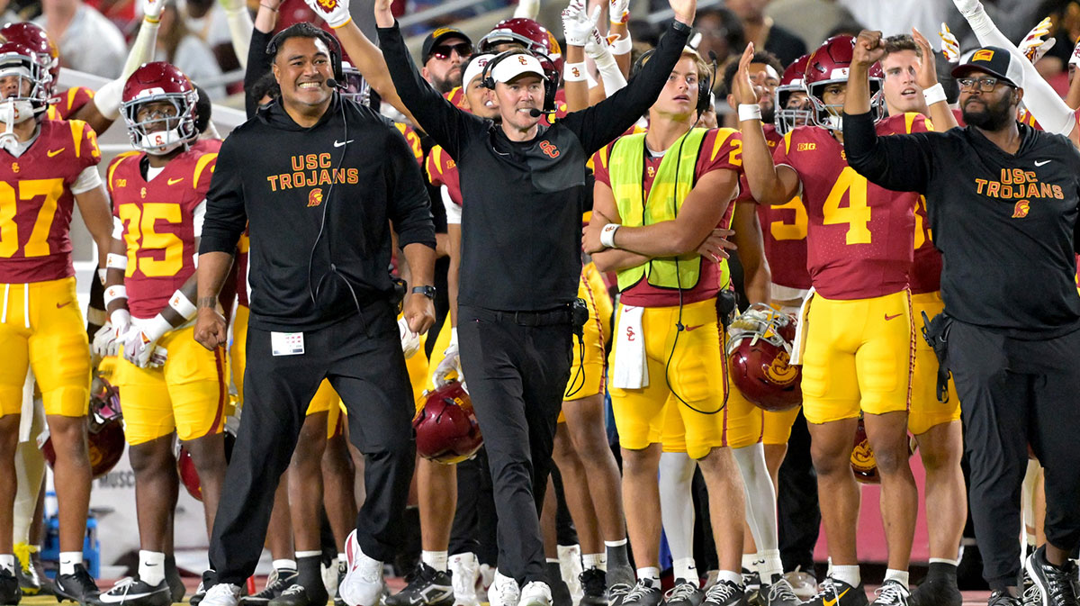 USC Trojans head coach Lincoln Riley (wearing white visor) celebrates along with defensive end coach Shaun Nua after kicker Ryon Sayeri (48) hit a 54-yard field goal in the second half against the Michigan Wolverines at United Airlines Field at the Los Angeles Memorial Coliseum.