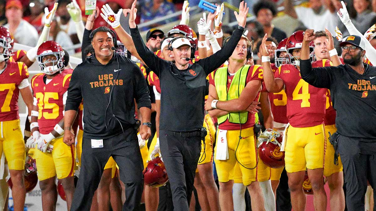 USC Trojans head coach Lincoln Riley (wearing white visor) celebrates along with defensive end coach Shaun Nua after kicker Ryon Sayeri (48) hit a 54-yard field goal in the second half against the Michigan Wolverines at United Airlines Field at the Los Angeles Memorial Coliseum.