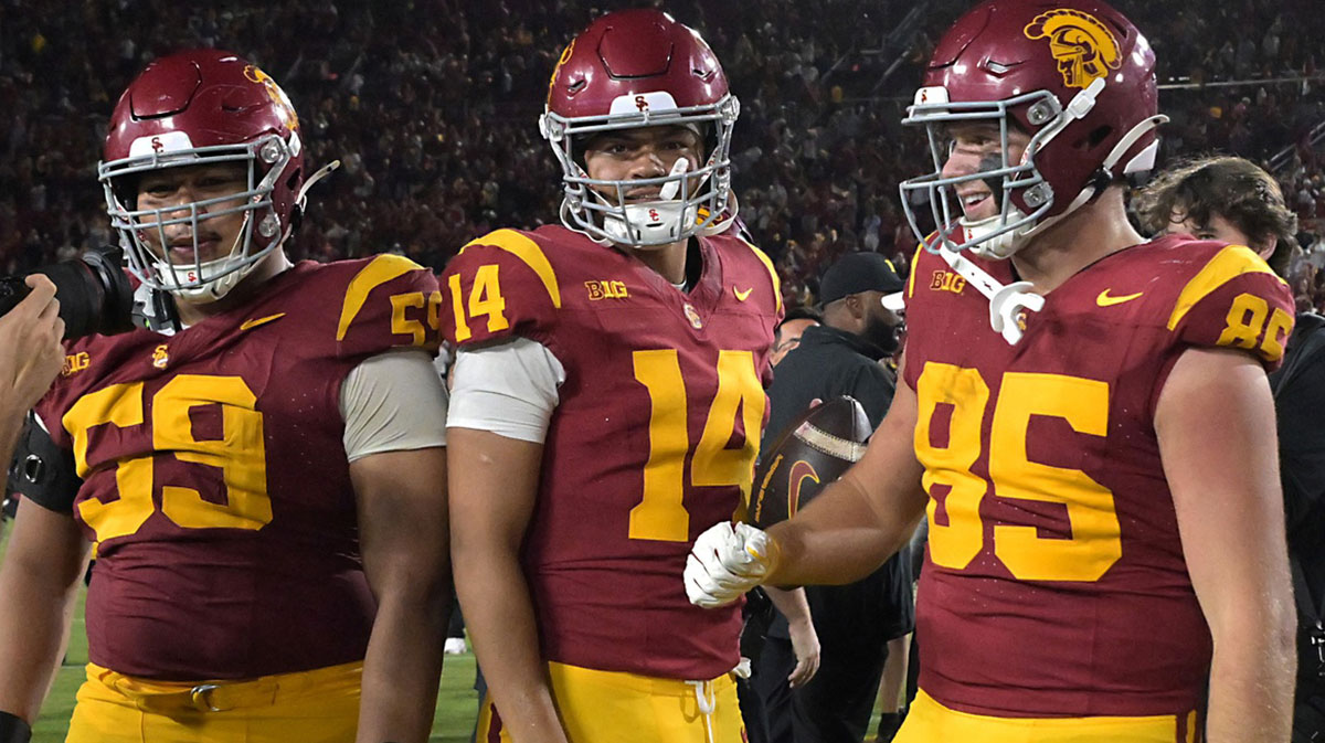 USC Trojans offensive lineman Micah Banuelos (59), quarterback Jayden Maiava (14) and USC Trojans defensive end Jadyn Ramos (95) celebrate after defeating the Michigan Wolverines at United Airlines Field at the Los Angeles Memorial Coliseum. Mandatory Credit: Jayne Kamin-Oncea-Imagn Images