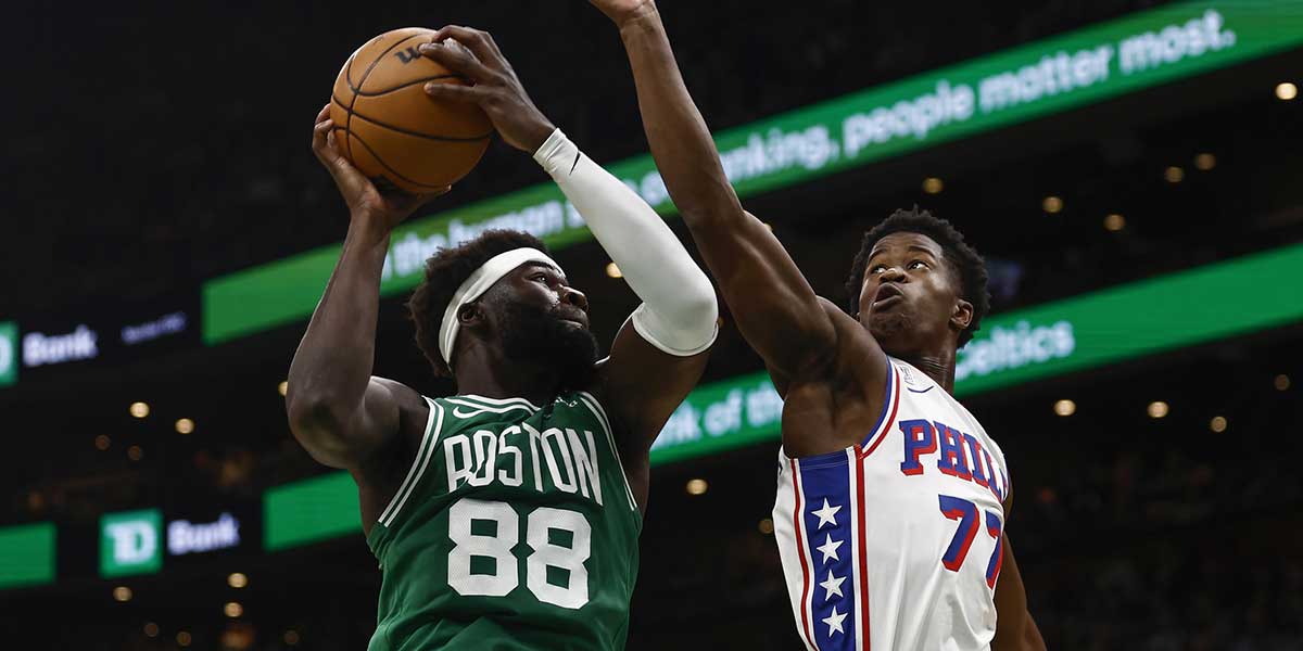 Boston Celtics center Neemias Queta (88) grabs a rebound next to Philadelphia 76ers guard VJ Edgecombe (77) during the first quarter at TD Garden.