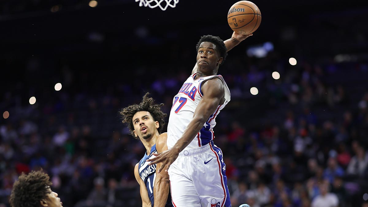 Philadelphia 76ers guard Vj Edgecombe (77) is fouled by Minnesota Timberwolves guard Jules Bernard (14) while driving for a dunk during the fourth quarter at Xfinity Mobile Arena.
