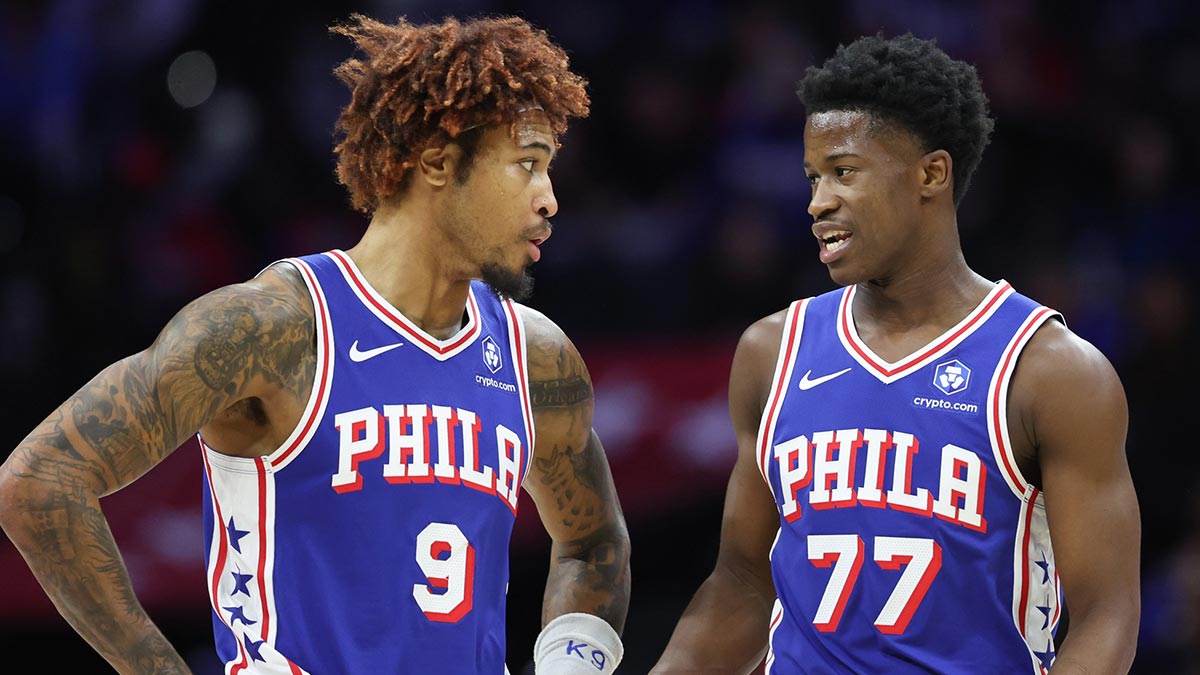 Philadelphia 76ers guard Kelly Oubre Jr. (9) and guard VJ Edgecombe (77) talk during a break in the first quarter against the Orlando Magic at Xfinity Mobile Arena.