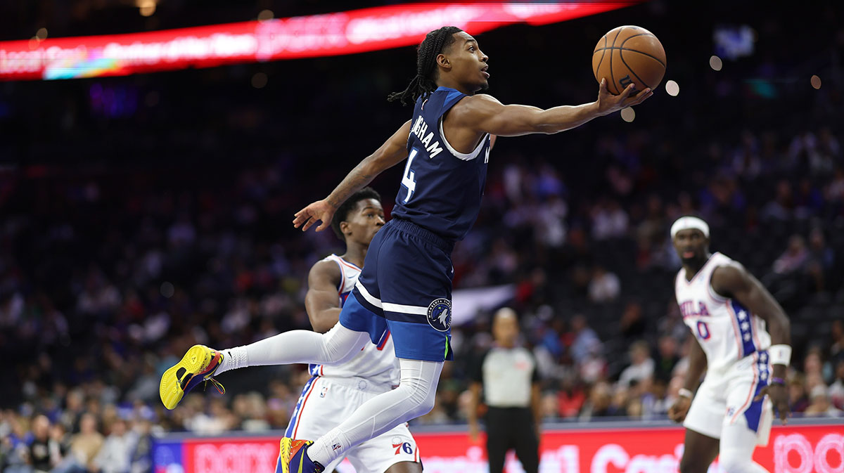 Minnesota Timberwolves guard Rob Dillingham (4) drives for a shot past Philadelphia 76ers guard Vj Edgecombe (77) during the first quarter at Xfinity Mobile Arena.