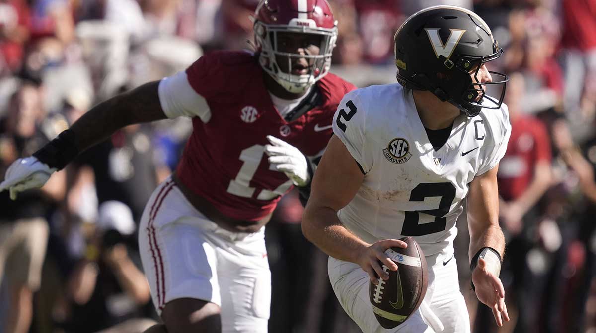Vanderbilt quarterback Diego Pavia (2) rolls away from pressure by Alabama linebacker Kelby Collins (17) at Saban Field at Bryant-Denny Stadium.