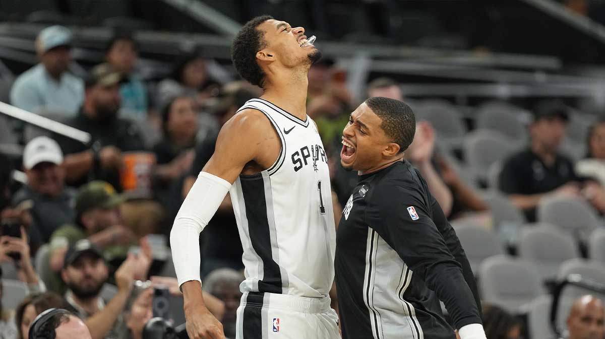 San Antonio Spurs forward Victor Wembanyama (1) forward Keldon Johnson (3) bump chests before the game against the Indiana Pacers at Frost Bank Center.