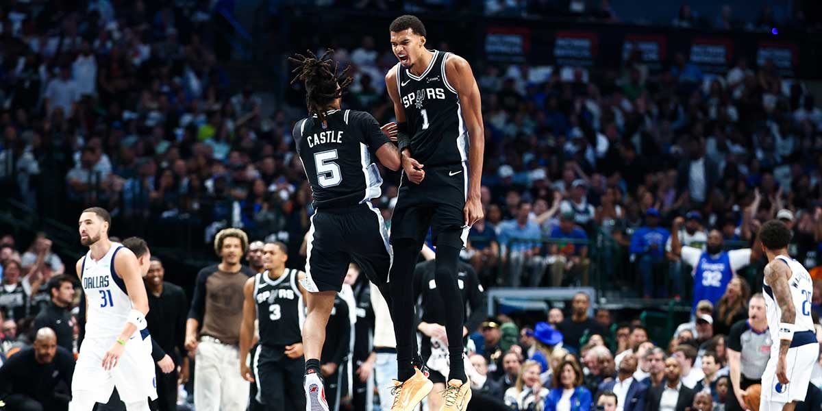 San Antonio Spurs forward Victor Wembanyama (1) celebrates with San Antonio Spurs guard Stephon Castle (5) during the first half against the Dallas Mavericks at American Airlines Center.