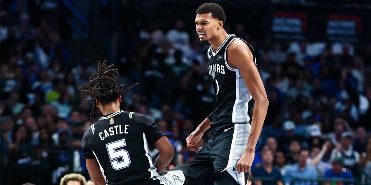 San Antonio Spurs forward Victor Wembanyama (1) celebrates with San Antonio Spurs guard Stephon Castle (5) during the first half against the Dallas Mavericks at American Airlines Center.