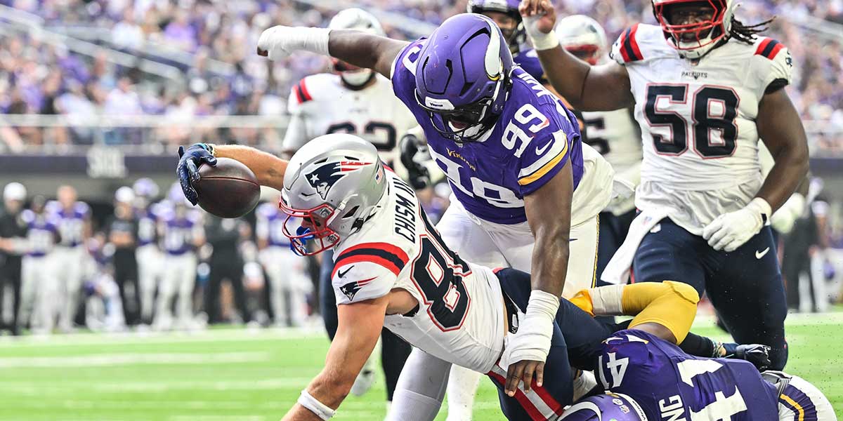 New England Patriots wide receiver Efton Chism III (86) scores a touchdown as Minnesota Vikings linebacker Kobe King (41) and defensive end Alex Williams (99) attempt to make the stop during the second quarter at U.S. Bank Stadium