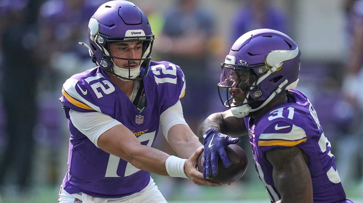 Minnesota Vikings quarterback Max Brosmer (12) hands off to running back Cam Akers (31) in the fourth quarter of the NFL Week 3 game between the Minnesota Vikings and the Cincinnati Bengals.