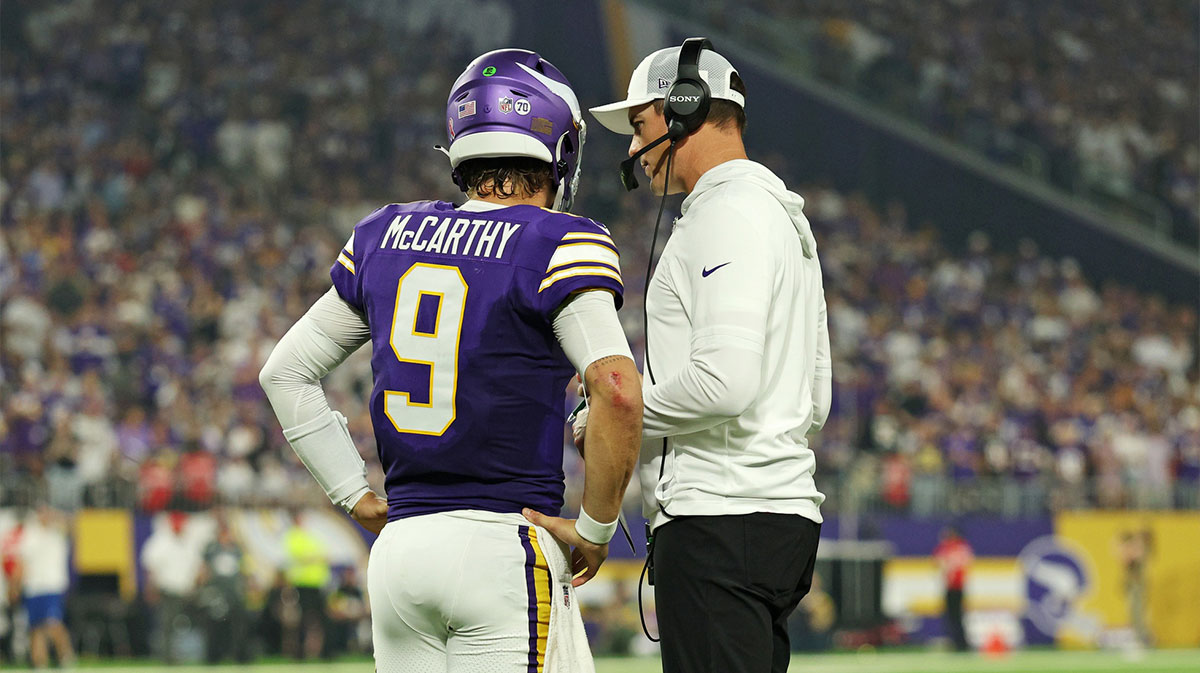 Minnesota Vikings quarterback J.J. McCarthy (9) speaks with Minnesota Vikings head coach Kevin O'Connell during the first half against the Atlanta Falcons at U.S. Bank Stadium.