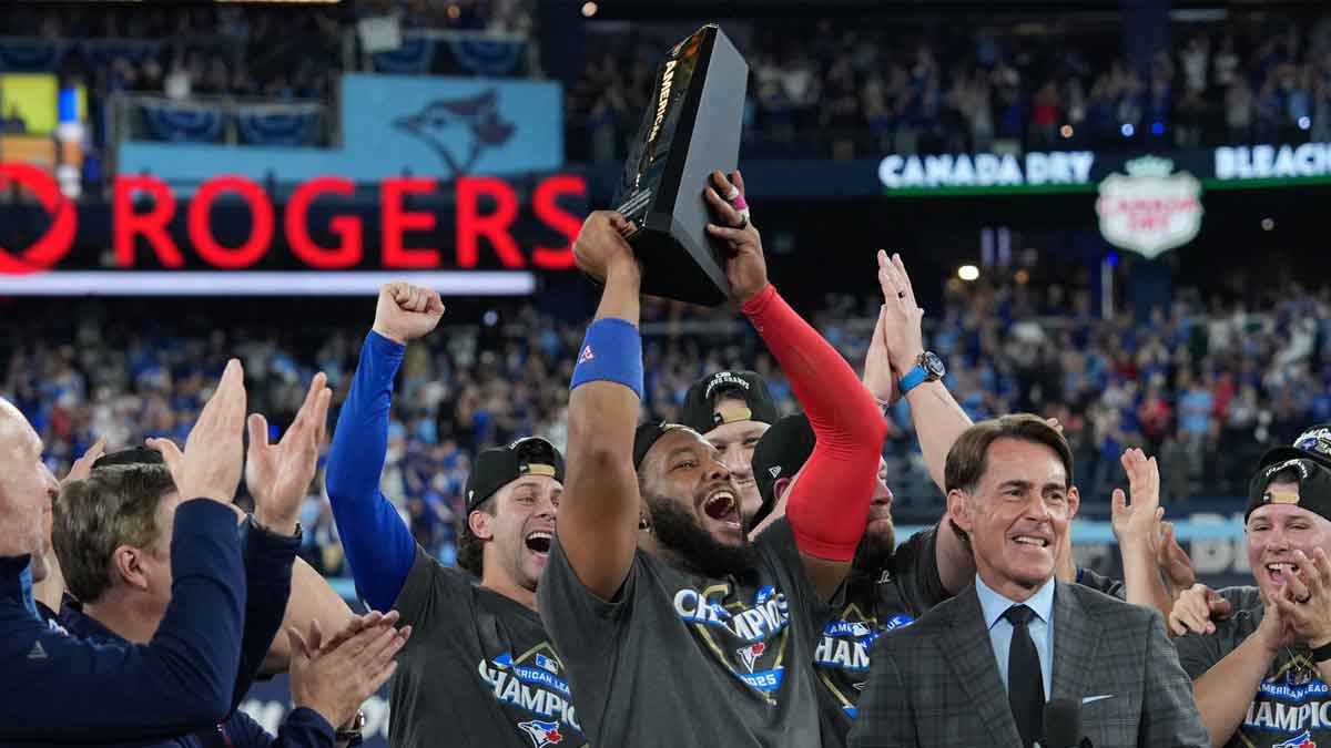 Toronto Blue Jays first baseman Vladimir Guerrero Jr. (27) celebrates with the trophy after defeating the Seattle Mariners in game seven of the ALCS round for the 2025 MLB playoffs at Rogers Centre.