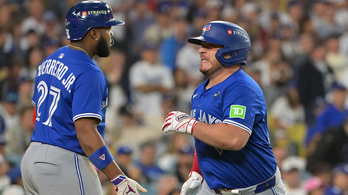 Toronto Blue Jays catcher Alejandro Kirk (30) celebrates with first baseman Vladimir Guerrero Jr. (27) after hitting a three run home run against the Los Angeles Dodgers in the fourth inning during game three of the 2025 MLB World Series at Dodger Stadium.