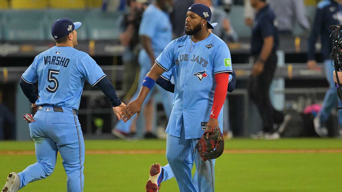 Toronto Blue Jays first baseman Vladimir Guerrero Jr. (27) celebrates with Toronto Blue Jays center fielder Daulton Varsho (5) after the game against the Los Angeles Dodgers during game four of the 2025 MLB World Series at Dodger Stadium.