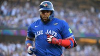 Toronto Blue Jays first baseman Vladimir Guerrero Jr. (27) returns to the dugout in the first inning against the Los Angeles Dodgers during game three of the 2025 MLB World Series at Dodger Stadium.