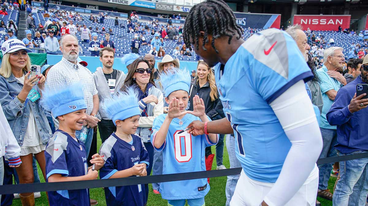 Jude Cole, 9, Cam Ziegler, 9 andHenry Kirven, 10 meet Tennessee Titans quarterback Cam Ward (1) before the game against the New England Patriots at Nissan Stadium in Nashville, Tenn., Sunday, Oct. 19, 2025.
