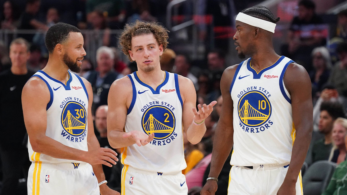 Warriors guard Stephen Curry (30), guard Brandin Podziemski (2), and forward Jimmy Butler III (10) talk during a break in the action against the Los Angeles Lakers in the second quarter at Chase Center