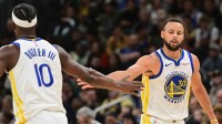 Golden State Warriors guard Stephen Curry (30) reacts with forward Jimmy Butler (10) after scoring a basket in the 3rd quarter against the Milwaukee Bucks at Fiserv Forum.