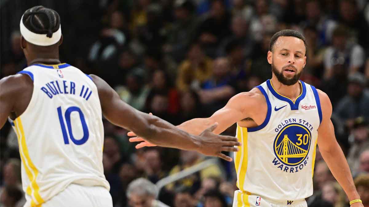 Golden State Warriors guard Stephen Curry (30) reacts with forward Jimmy Butler (10) after scoring a basket in the 3rd quarter against the Milwaukee Bucks at Fiserv Forum.