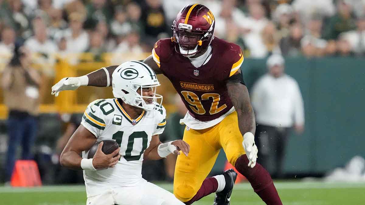 Washington Commanders defensive end Dorance Armstrong (92) sacks Green Bay Packers quarterback Jordan Love (10) in the fourth quarter at Lambeau Field.