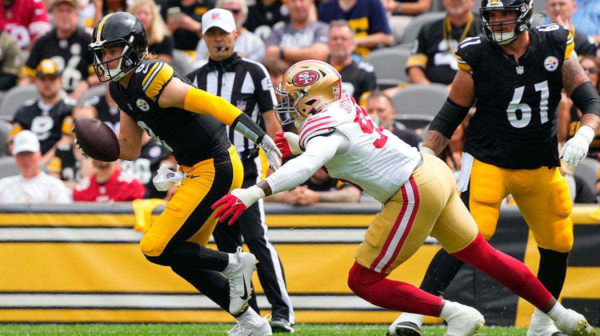 Pittsburgh Steelers quarterback Kenny Pickett (8) and San Francisco 49ers defensive end Drake Jackson (95) during the first half at Acrisure Stadium.