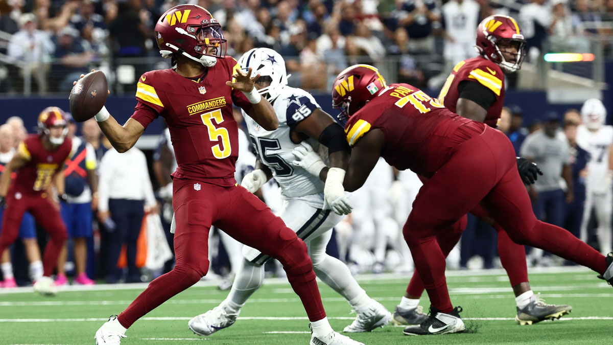 Washington Commanders quarterback Jayden Daniels (5) passes the ball under pressure from Dallas Cowboys nose tackle Kenny Clark (95) during the second quarter of the game at AT&T Stadium.