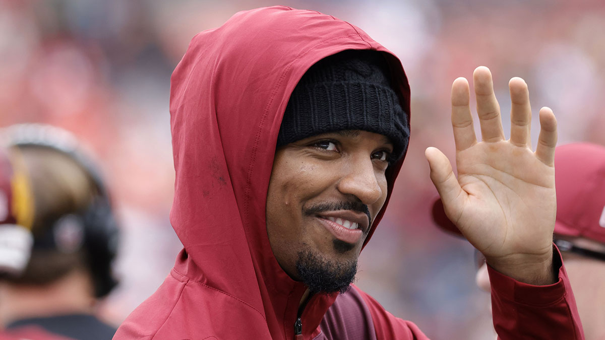 Injured Washington Commanders quarterback Jayden Daniels waves to fans while walking off the field after the Commanders' game against the Las Vegas Raiders at Northwest Stadium.