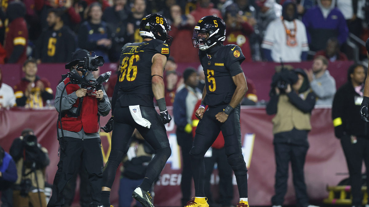 Washington Commanders wide receiver Zach Ertz (83) celebrates scoring a touch down with Jayden Daniels (5