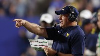 West Virginia Mountaineers head coach Rich Rodriguez coaches during the fourth quarter against the Brigham Young Cougars at LaVell Edwards Stadium.