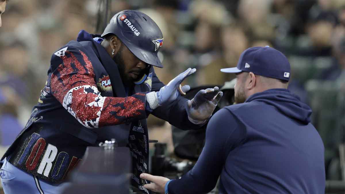 Toronto Blue Jays first baseman Vladimir Guerrero Jr. (27) celebrates with manager John Schneider (14) after hitting home run in the fifth inning against the Seattle Mariners during game three of the ALCS round for the 2025 MLB playoffs at T-Mobile Park.