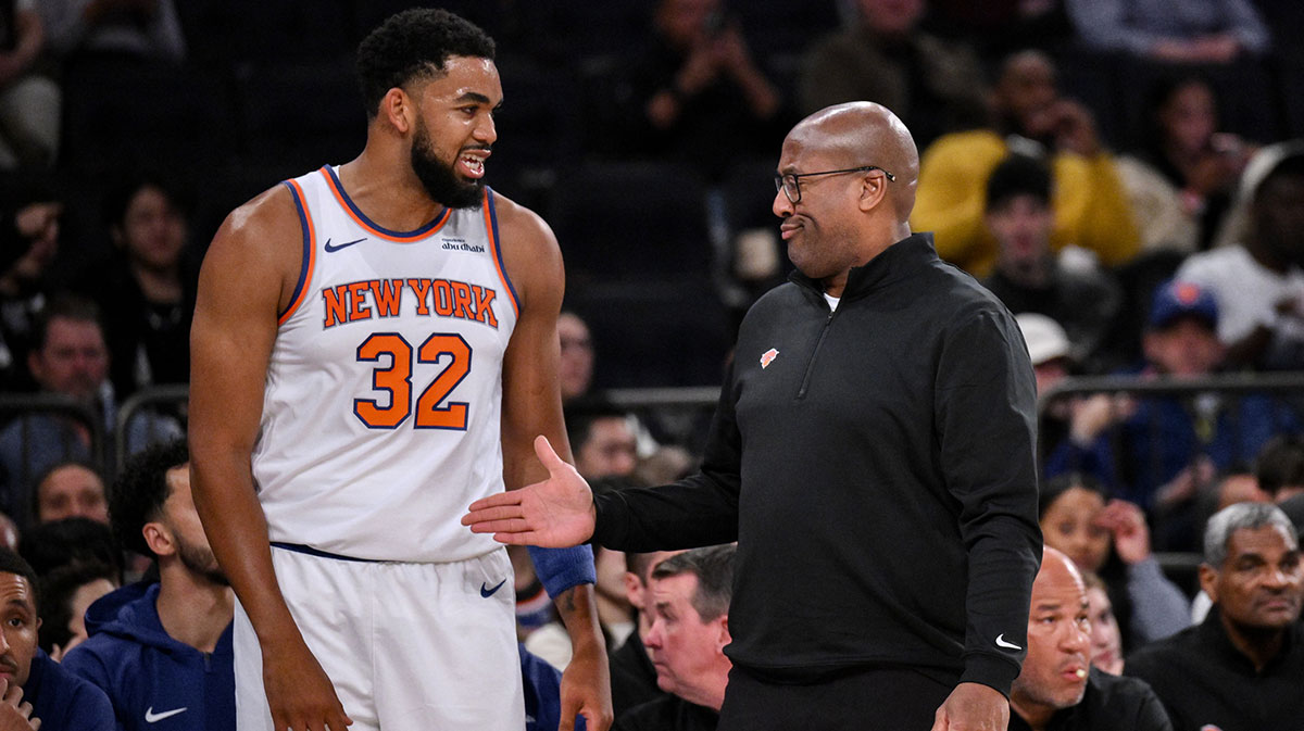 Oct 9, 2025; New York, New York, USA; New York Knicks head coach Mike Brown reacts as he talks with center/forward Karl-Anthony Towns (32) during the first half against the Minnesota Timberwolves at Madison Square Garden. Mandatory Credit: John Jones-Imagn Images