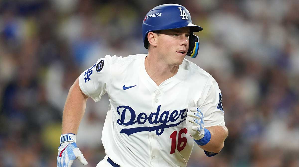 Los Angeles Dodgers catcher Will Smith (16) runs after hitting a single against the Milwaukee Brewers in the third inning during game four of the NLCS round for the 2025 MLB playoffs at Dodger Stadium.