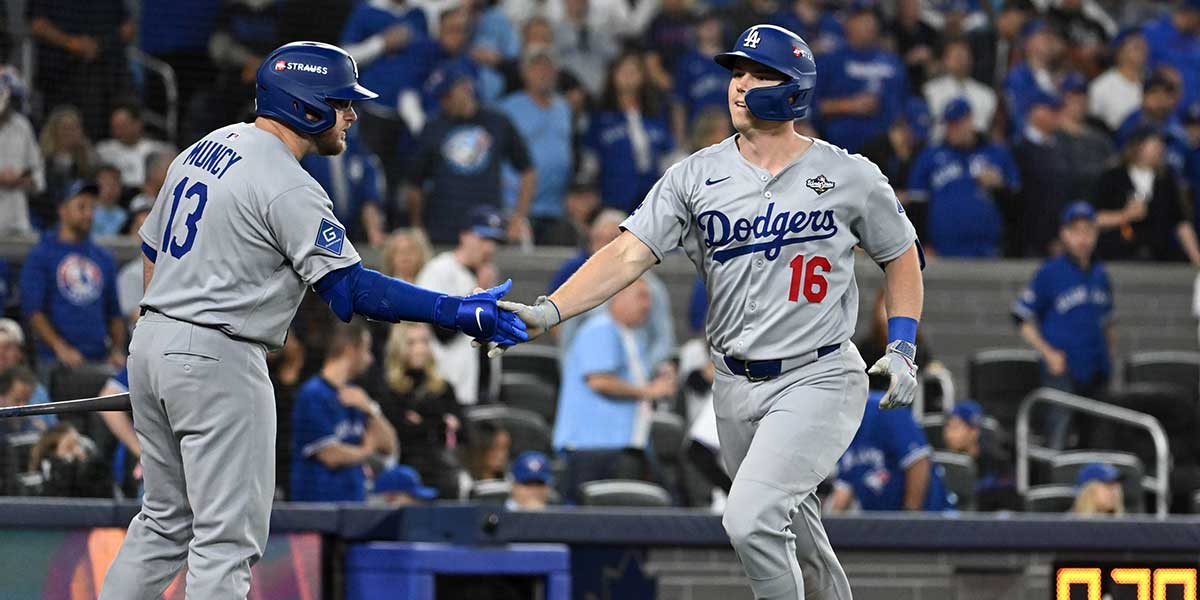 Los Angeles Dodgers catcher Will Smith (16) celebrates after hitting a solo home run against the Toronto Blue Jays with third baseman Max Muncy (13) in the seventh inning during game two of the 2025 MLB World Series at Rogers Centre.