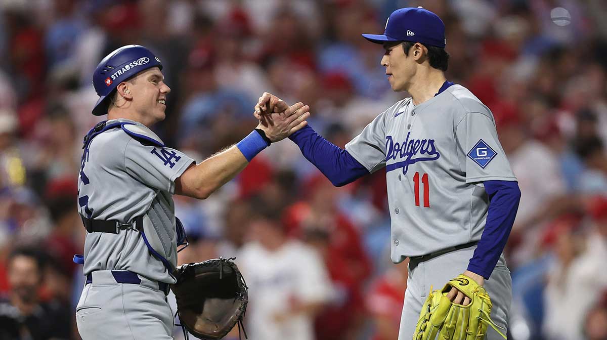Los Angeles Dodgers pitcher Roki Sasaki (11) and catcher Will Smith (16) celebrate after defeating the Philadelphia Phillies in game one of the NLDS round for the 2025 MLB playoffs at Citizens Bank Park.